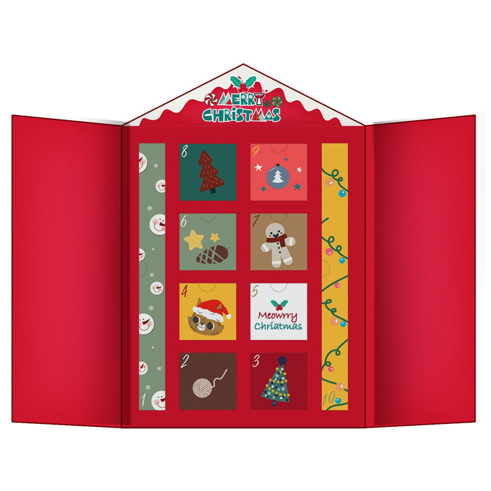 Geöffnete rote XMAS-Geschenkbox mit verschiedenen Katzenspielzeugen